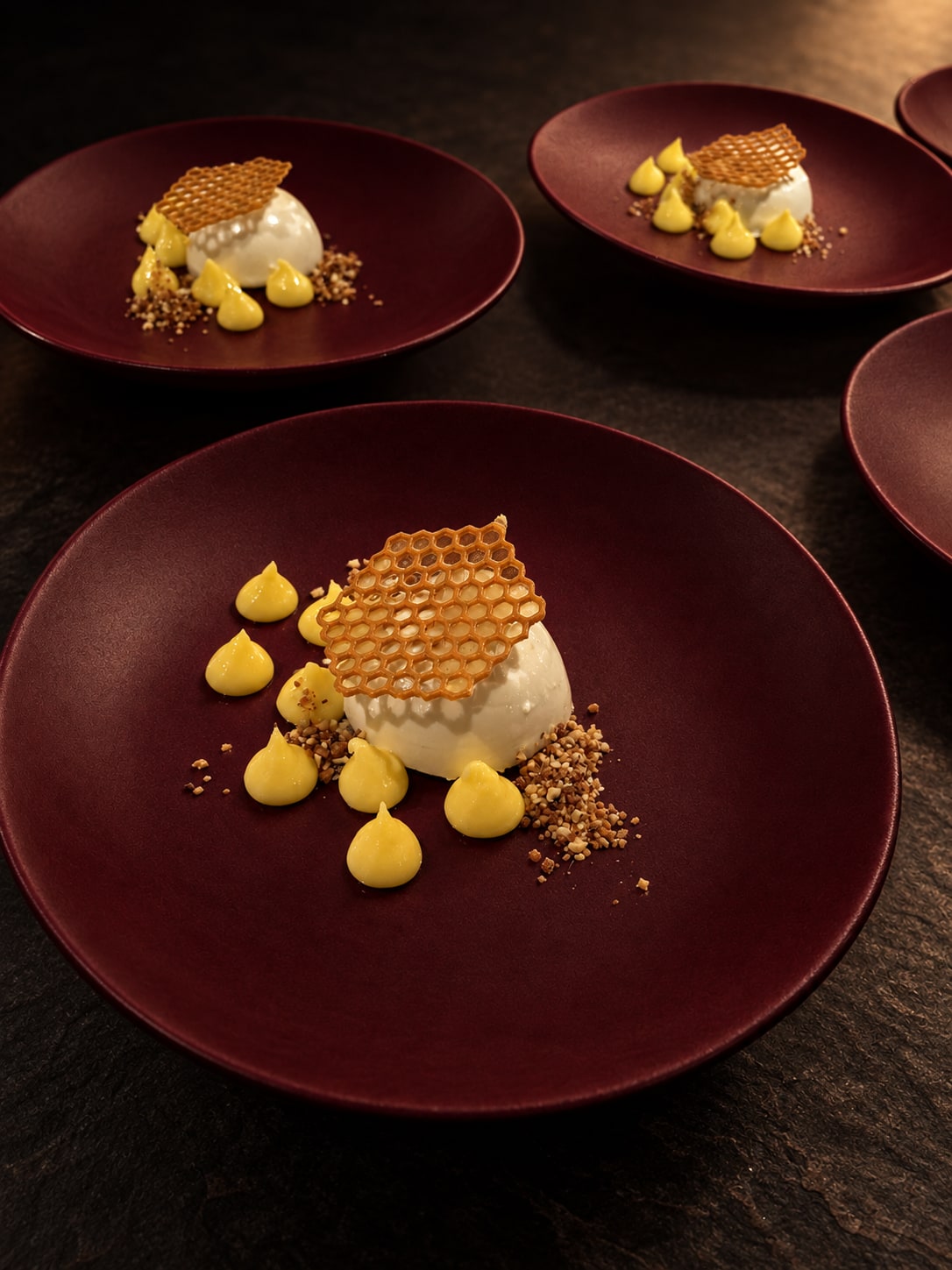 Honeycomb-topped dessert on burgundy plates