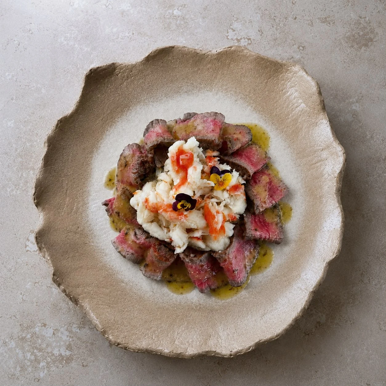 A composed dish with sliced meat, shellfish, and delicate garnishes